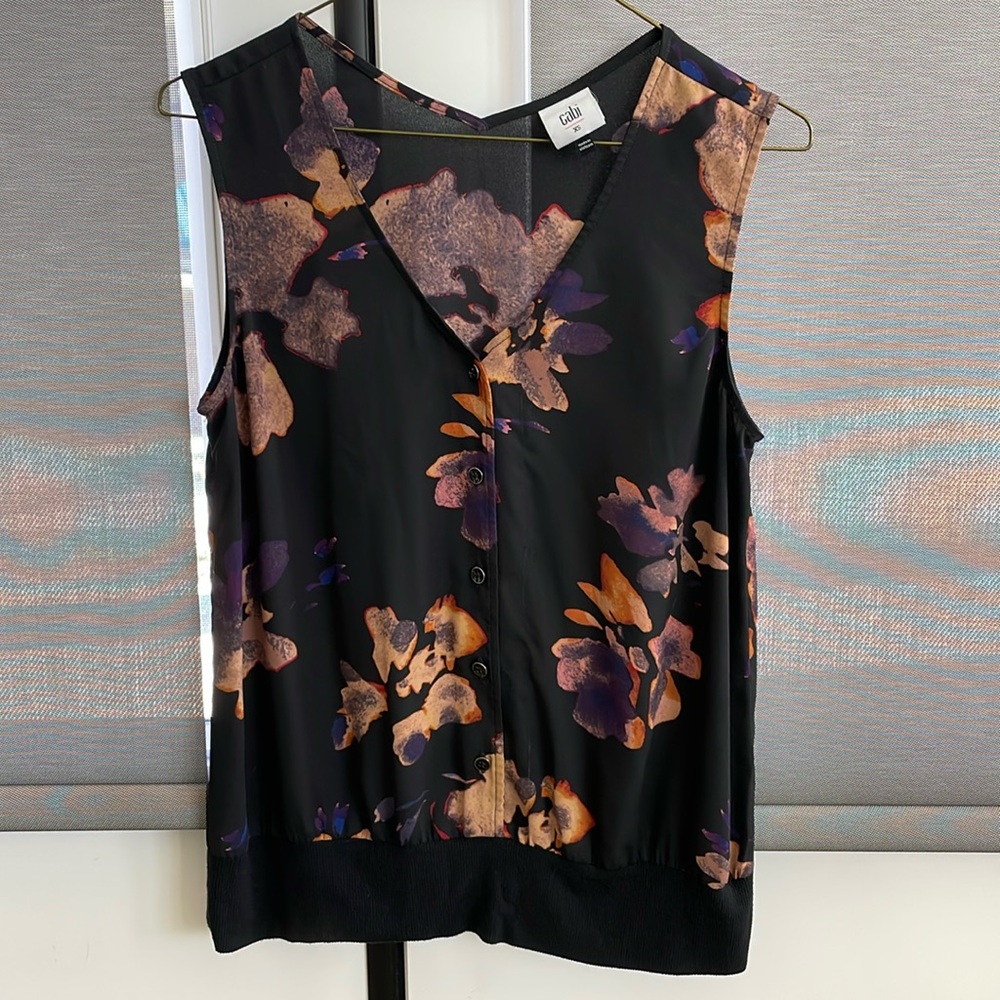 Black with flower pattern sleeveless blouse.
